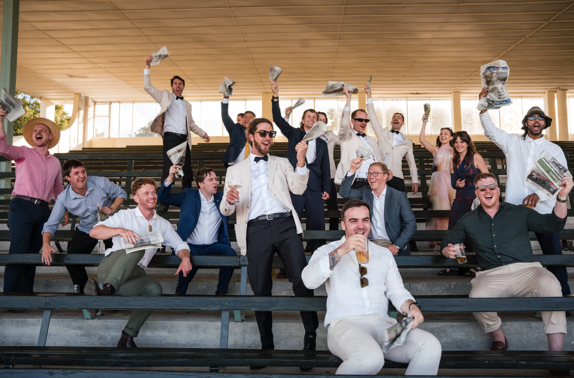 A crowd cheering in a grandstand at an event